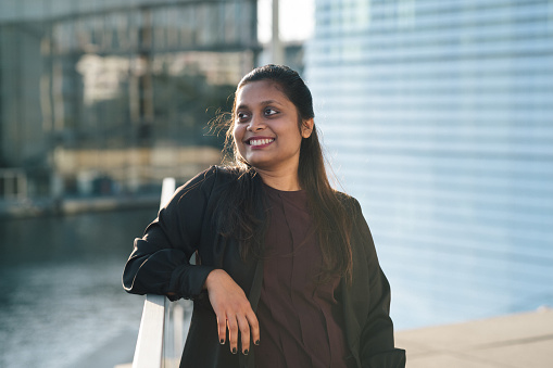 Portrait of a confident Indian woman in front of Modern Office Architecture