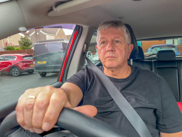 istock Senior man driving in car 1414174634