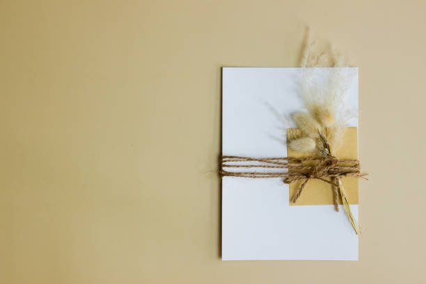 istock White letter with flower over the brown background. 1414176172