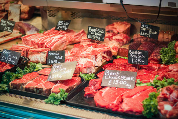 Counter of a butcher's shop in Borough Market in London, England Counter of a butcher's shop displaying various cuts and preparations of meat in Borough Market in London, England boneless chuck steak stock pictures, royalty-free photos & images