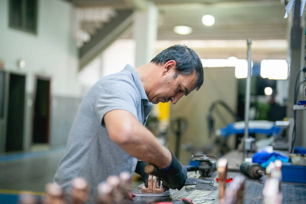 istock Blue collar worker working on a metal part 1414180510