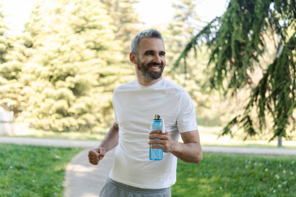 istock Happy handsome man enjoying running in the park 1414180657