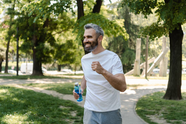 istock Happy man enjoying running outdoors 1414181404