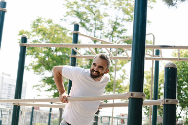 istock Handsome mature man doing strength training at the park gym 1414181529