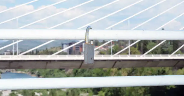 a lock on a white bridge handle