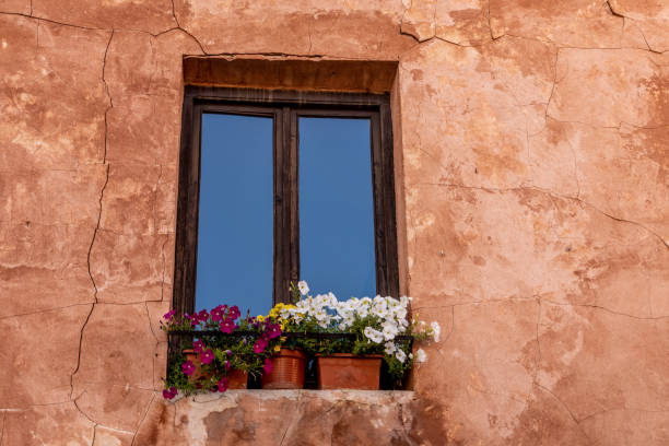 istock Wooden windows  flowers stucco wall 1414182497