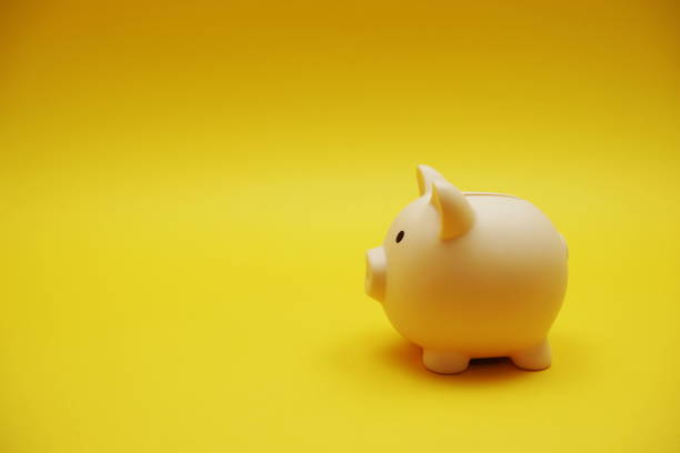 istock Piggy banks saving with space copy on yellow background 1414189559