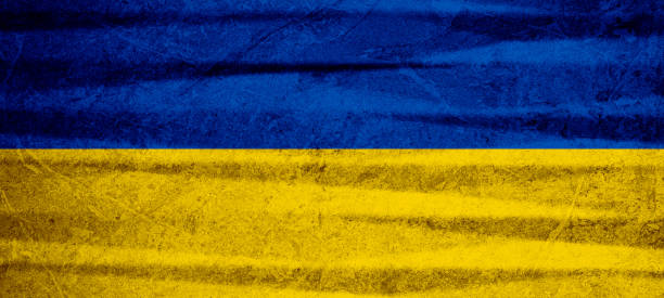 istock Ukrainian flag background banner panorama - Old rustic damaged concrete stone wall texture background, painted in the colors of the flag of Ukraine.. 1414191596