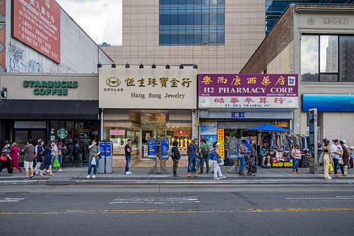 Main Street, Flushing downtown, Queens, New York, NY, USA - July 2 2022: View across the street to the American Chinese shops and street life