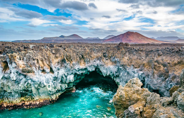 amazing view of lava's caves los hervideros and volcanoes in lanzarote island, popular touristic attraction. location: lanzarote, canary islands, spain. artistic picture. beauty world. travel concept. - lanzarote imagens e fotografias de stock