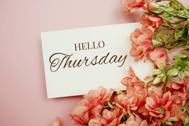 istock Hello Thursday typography text with flowers frame on pink background 1414192920