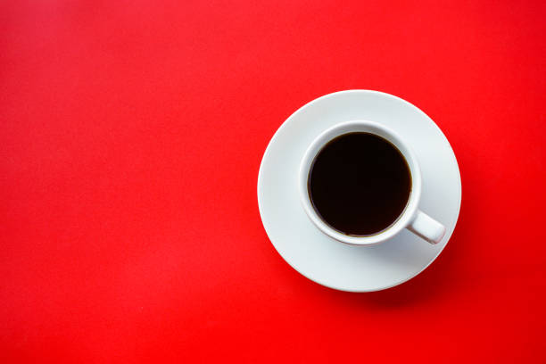 istock Flat lay view of dark hot coffee cup on red background with copy space 1414194347