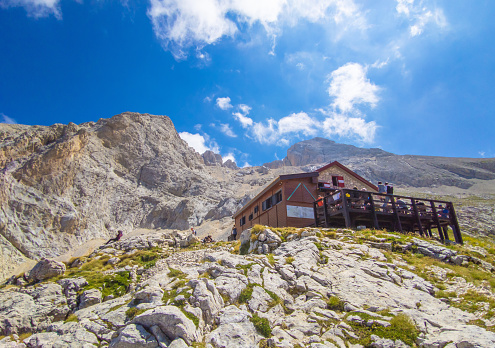 Gran Sasso, Italy - 31 July 2022 - The extreme trekking to Vetta Orientale of Corno Grande, 2902 meters in Abruzzo region, with Ferrata Ricci climbing way, glacier of Calderone and Rifugio Franchetti. Here in particular the Rifugio Franchetti building