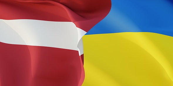 Latvian and Ukrainian flags flying in the wind. Latvia stand with Ukraine. 3D rendered image.