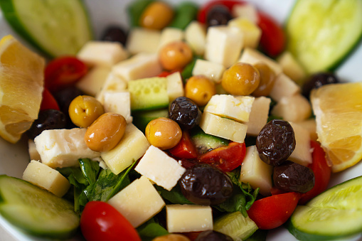 Cheese platter with different sorts of cheese and grapes on wood