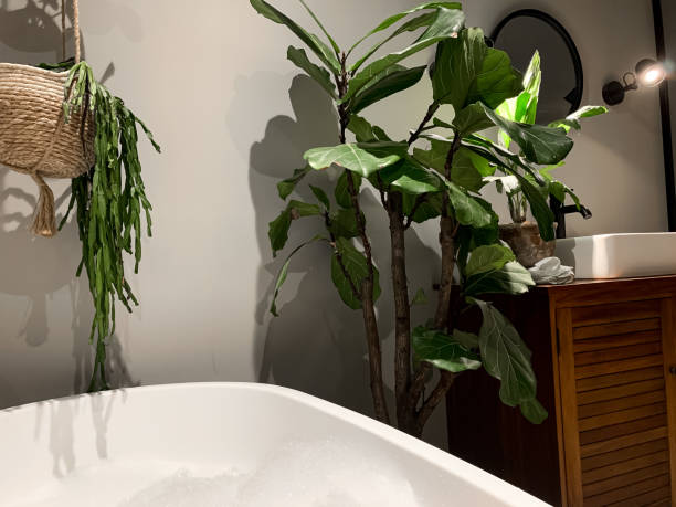 istock Charming cozy bathroom view. Bath tube by the window. 1414205329