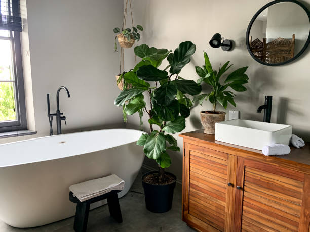 istock Charming cozy bathroom view. Bath tube by the window. 1414205411