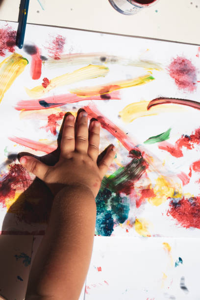 istock child hand painting with tempera paint 1414205448