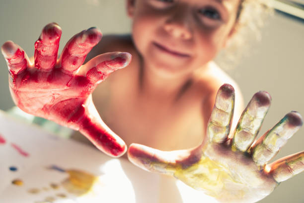 girl hands painted with paint stock photo