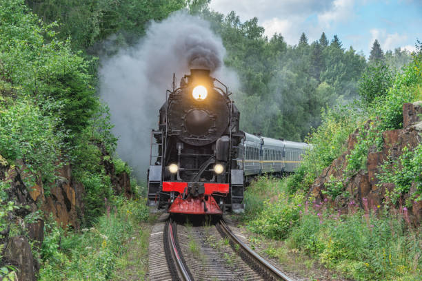 istock Retro steam train approaches to the platform. 1414207192
