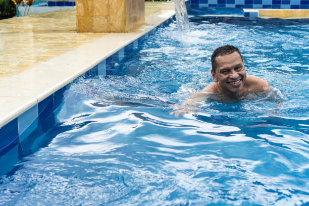 Latin man swimming in the pool