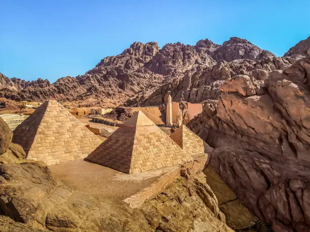 Copies of the Egyptian pyramids among the desert stone mountains near Sharm El Sheikh, Egypt. Tourist buildings in the Sinai desert