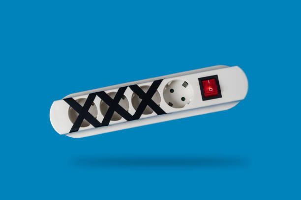 Multi-socket power strip with some of them blocked. Concept of energy saving or restriction and responsible use of electricity