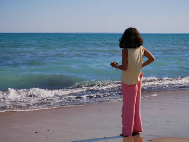 Beautiful photo of a girl seen from behind on the beach