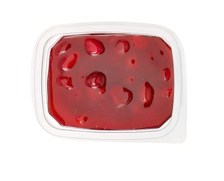 Cranberry sauce in plastic tray isolated on white background