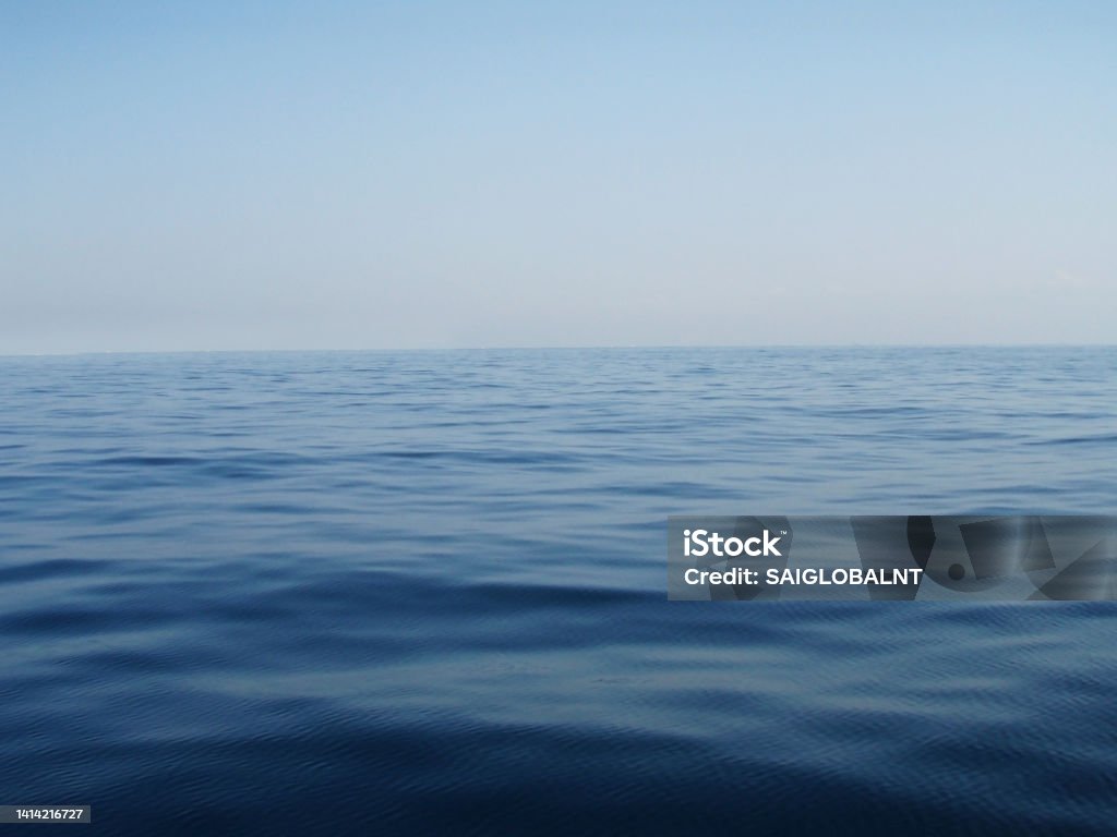 Pale morning sky and the dead calm blue sea horizon gradation texture. Fog Stock Photo