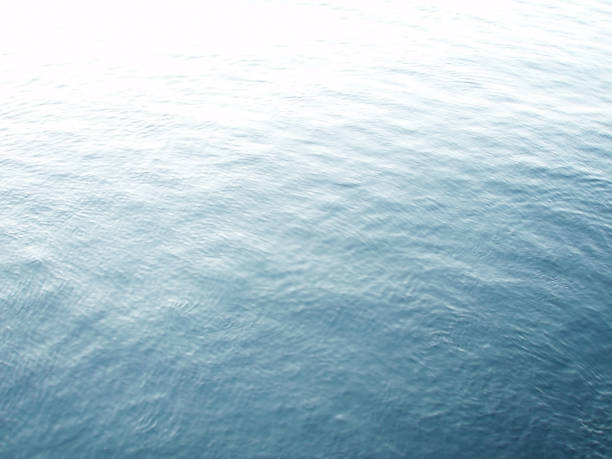 istock Sun beam reflected on the sea surface, high contrast image photograph. 1414216781