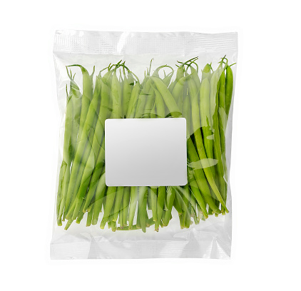 haricots verts in plastic bag with copy space, isolated on white