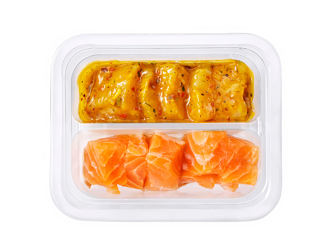 raw cod and salmon in plastic tray isolated on white