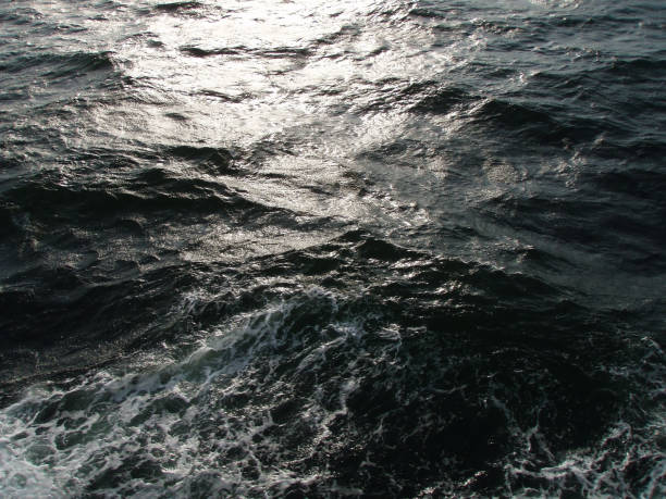 Dark ocean surface and rough wave image processed photograph, taken from the sailing boat. stock photo