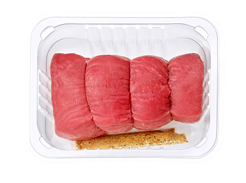 beef roulade with herbs in plastic tray isolated on white with clipping path