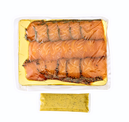 smoked salmon in a plastic tray isolated on white.
