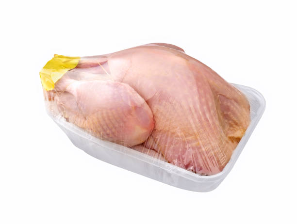 raw turkey on plastic tray isolated on white