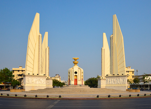 Bangkok, Thailand: Democracy Monument, architect Chitrasen Aphaiwong, 1939 - the center of the monument is a palm-leaf manuscript box holding the Thai Constitution of 1932, on top of two golden offering bowls above a round turret. The constitution is guarded by four wings, representing the branches of the Thai armed forces, which carried out the 1932 coup - traffic circle on the wide east-west Ratchadamnoen Avenue, at the intersection of Dinso Road