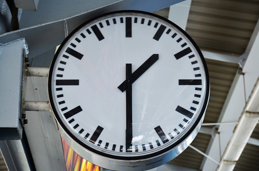 double exposure of row of coins and clock for business and finance