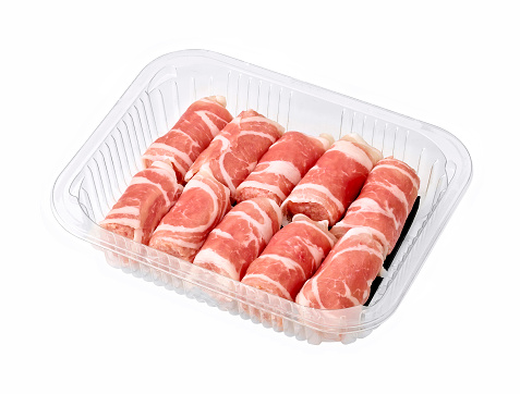 a pack of raw sausages on a white background