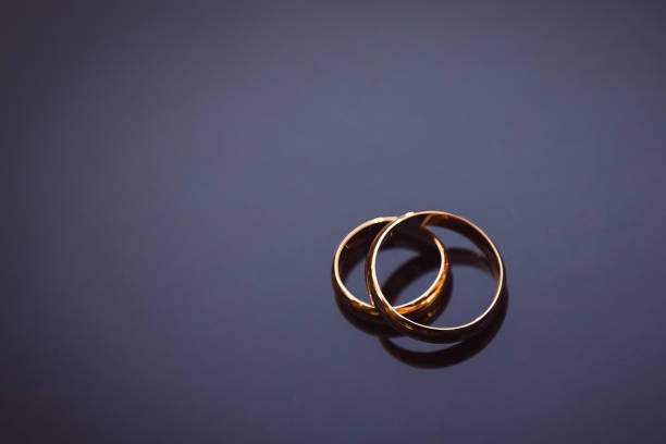 istock Pair of gold rings on dark blue background 1414221373