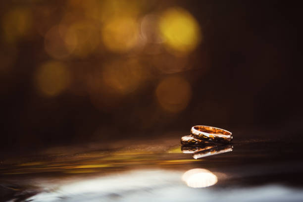 Wedding rings in between splashing water drops, selective focus