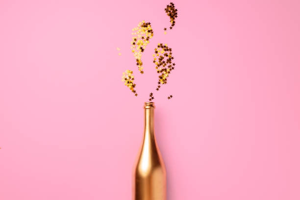 istock Champagne bottle with confetti flat lay top view 1414222659