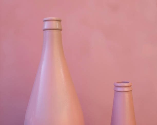 istock Close-up of Two Empty Bottles. Pink Bottles on a Pink Background. 1414223069