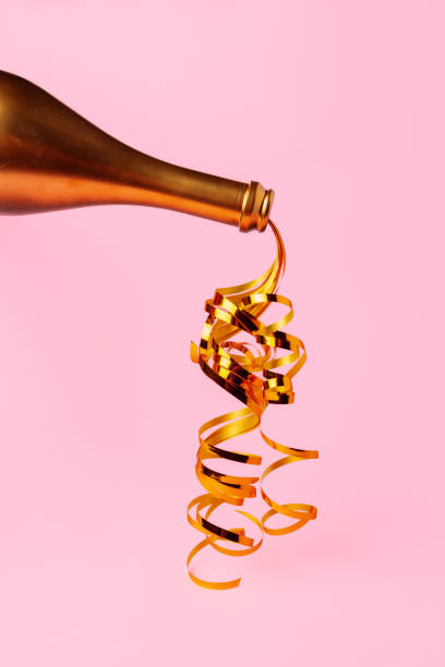 istock Champagne bottle with streamers flat lay top view 1414223215