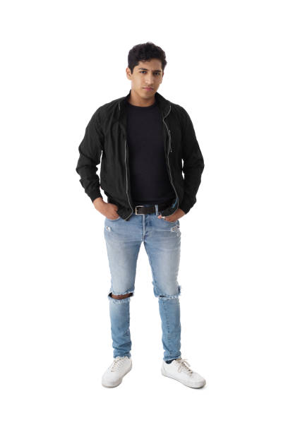 istock Young man standing with hands in pockets 1414226415
