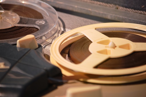 Reel of magnetic tape on a vintage tape recorder