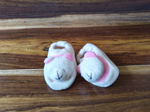 istock Baby shoes on wooden table 1414230288