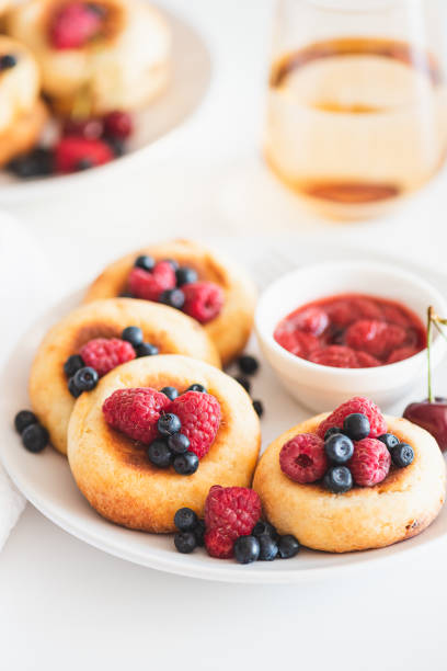 istock Homemade cottage cheese pancakes with fresh berries on white table 1414233265
