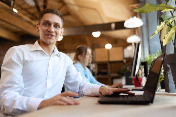 istock Senior developer. Happy man looking at camera and smilling. Work in modern loft style office using devices and gadgets during job processing. 1414233875